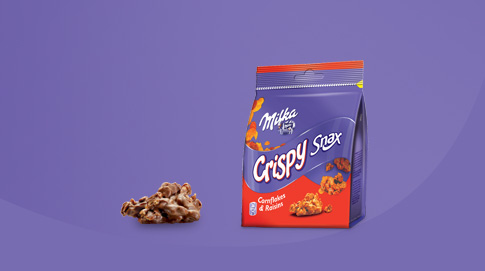 Crispy Snax é um snack elaborado com flocos de milho e passas, coberto com cremoso chocolate de leite Milka.